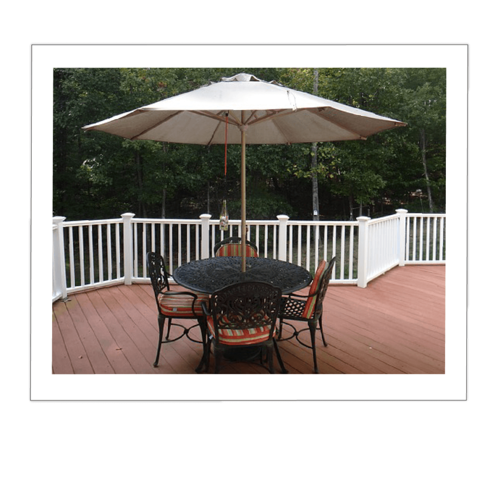 photo of wrought iron patio table and chairs with an umbrella