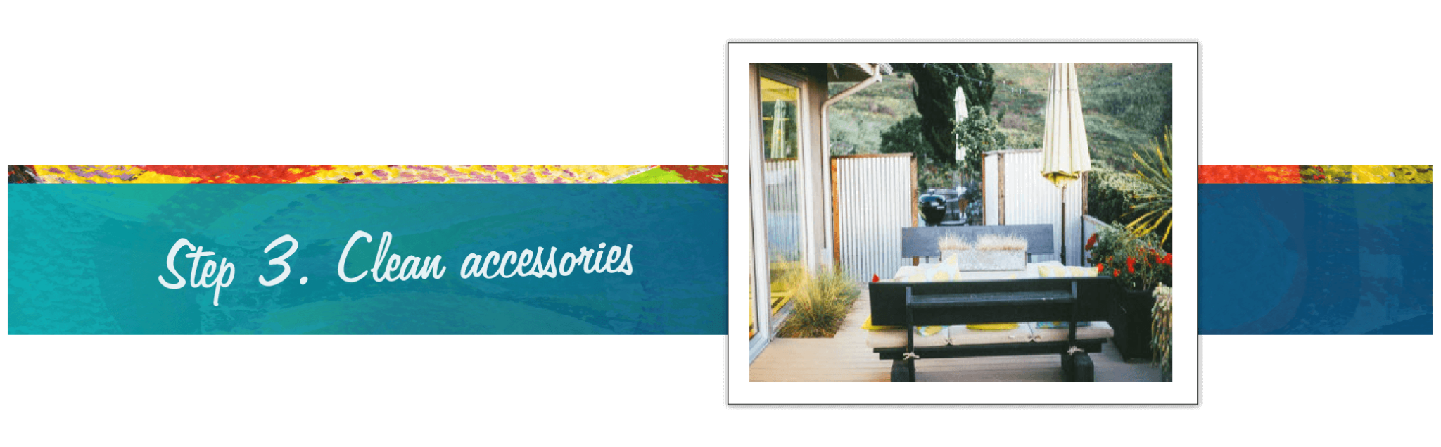 Photo of outdoor deck with plants, a wooden table and bench in an open air setting with a variety of plants and distinctive tablecloth with matching umbrella.