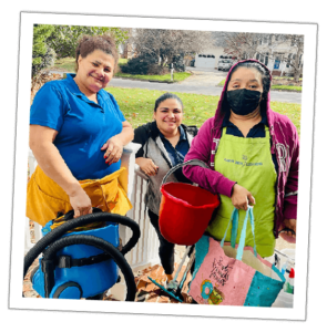 an image of three women employees of carpe diem smiling with cleaning products