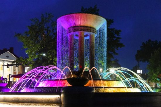 Colorful water fountain at dusk in downtown Cary, North Carolina.
